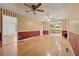 Dining area featuring hardwood floors and vintage wallpaper, adjacent to the kitchen at 1926 Parkwood Rd, Snellville, GA 30078