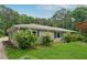 A charming home featuring a well-manicured lawn and mature trees surrounding the property at 1926 Parkwood Rd, Snellville, GA 30078