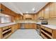 Updated kitchen featuring custom wood cabinets, stainless steel appliances, and tile floors at 1926 Parkwood Rd, Snellville, GA 30078