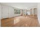 Bright living room with hardwood floors, built-in shelving, and a large window overlooking the lush yard at 1926 Parkwood Rd, Snellville, GA 30078