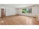 Bright living room with hardwood floors and a large window overlooking the lush green yard at 1926 Parkwood Rd, Snellville, GA 30078