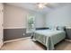 Charming bedroom featuring a large window, baseboard trim, and a queen size bed with blue bedding at 2715 Braemore Gln, Powder Springs, GA 30127