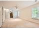 Spacious bonus room with a ceiling fan, large windows, and stair access at 2715 Braemore Gln, Powder Springs, GA 30127