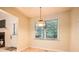 Sunny dining area with a classic chandelier and large windows overlooking the yard at 2715 Braemore Gln, Powder Springs, GA 30127