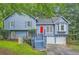 Charming two-story home with blue siding, a red door, and a well-maintained lawn at 2715 Braemore Gln, Powder Springs, GA 30127