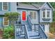 Inviting front porch with a red door and stylish railings on a blue home at 2715 Braemore Gln, Powder Springs, GA 30127