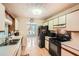 Well-lit kitchen with white cabinets, wood accents, and a view into the dining area at 2715 Braemore Gln, Powder Springs, GA 30127