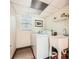 Functional laundry room features a utility sink, laundry machine, and bright natural lighting at 2715 Braemore Gln, Powder Springs, GA 30127