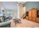 Bright living room with a ceiling fan, high ceilings and view of the home's entrance and staircase at 2715 Braemore Gln, Powder Springs, GA 30127