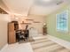 Home office features a neutral palette, window with blinds, desk, chair, shelves, and a striped rug at 2715 Braemore Gln, Powder Springs, GA 30127
