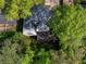 An aerial view of the home reveals a backyard patio area and lush trees surrounding the property at 2903 Monterey Dr, Decatur, GA 30032