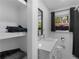Bright bathroom featuring open shelves and modern sink, mirror, and shower at 2903 Monterey Dr, Decatur, GA 30032