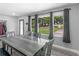 Inviting dining area showcasing large windows, modern flooring and a gray dining set at 2903 Monterey Dr, Decatur, GA 30032