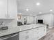 Open-concept kitchen with a large island, white cabinets, and views into the living area at 2903 Monterey Dr, Decatur, GA 30032