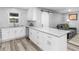 Eat-in kitchen featuring white cabinetry, granite countertops, a breakfast bar, and modern appliances at 2903 Monterey Dr, Decatur, GA 30032