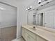 Bright bathroom featuring a long vanity with a large mirror and neutral tile floors at 3832 Cherry Ridge Blvd, Decatur, GA 30034