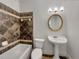 Bathroom with decorative tile walls, a pedestal sink, toilet, and tub with shower at 3832 Cherry Ridge Blvd, Decatur, GA 30034