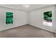 Bright bedroom with two windows, neutral carpet, and white walls at 3832 Cherry Ridge Blvd, Decatur, GA 30034
