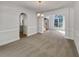 The dining room includes chair rail molding, chandelier, neutral walls, carpeted floors, and arched openings at 3832 Cherry Ridge Blvd, Decatur, GA 30034