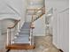 Bright foyer features a staircase with wooden railing and a tiled floor, leading to other areas of the home at 3832 Cherry Ridge Blvd, Decatur, GA 30034