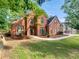 Charming two-story brick home with a landscaped yard and arched windows at 3832 Cherry Ridge Blvd, Decatur, GA 30034
