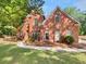 Charming two-story brick home with a landscaped yard and arched windows at 3832 Cherry Ridge Blvd, Decatur, GA 30034
