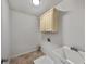 Cozy laundry room featuring a utility sink, cabinet and tile floors at 3832 Cherry Ridge Blvd, Decatur, GA 30034