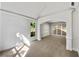 Open living room boasts neutral walls, a window, carpeted flooring, and arched entryways into other rooms at 3832 Cherry Ridge Blvd, Decatur, GA 30034