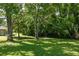 Expansive backyard with mature trees providing ample shade and a serene atmosphere at 762 Rockbridge Nw Rd, Lilburn, GA 30047