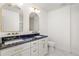 Modern bathroom with double sinks, marble countertops, and white cabinetry with gold hardware at 762 Rockbridge Nw Rd, Lilburn, GA 30047