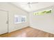 Bright bedroom with hardwood floors, two windows, and a white door creating a clean and open space at 762 Rockbridge Nw Rd, Lilburn, GA 30047