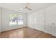 Well-lit bedroom with hardwood floors, white walls, and a double-door closet for ample storage at 762 Rockbridge Nw Rd, Lilburn, GA 30047