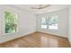 Bright bedroom featuring hardwood floors, white walls, and large windows offering natural light at 762 Rockbridge Nw Rd, Lilburn, GA 30047
