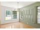 Dining room with decorative molding on the accent wall, large windows and hardwood floors at 762 Rockbridge Nw Rd, Lilburn, GA 30047