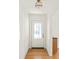 Bright foyer with a stained-glass front door, minimalist light fixture and wood flooring at 762 Rockbridge Nw Rd, Lilburn, GA 30047