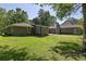 Exterior view of the home showcasing its well-maintained lawn and backyard space at 762 Rockbridge Nw Rd, Lilburn, GA 30047