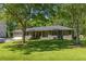 Charming brick ranch-style home with mature trees and a lush, well-manicured front lawn in a desirable neighborhood at 762 Rockbridge Nw Rd, Lilburn, GA 30047