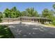 Ranch home with a three-car garage, lush landscaping and a long driveway with ample parking space at 762 Rockbridge Nw Rd, Lilburn, GA 30047