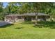 Charming brick ranch-style home with mature trees and a lush, well-manicured front lawn in a desirable neighborhood at 762 Rockbridge Nw Rd, Lilburn, GA 30047