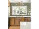 Close up of kitchen cabinets, sink, and countertops and backsplash, stainless dishwasher and lighting fixtures at 762 Rockbridge Nw Rd, Lilburn, GA 30047