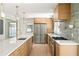 Bright kitchen with quartz countertops, stainless appliances, tile backsplash and modern lighting at 762 Rockbridge Nw Rd, Lilburn, GA 30047