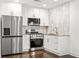 Modern kitchen featuring stainless steel appliances, white cabinets, granite countertops and eat in area at 762 Rockbridge Nw Rd, Lilburn, GA 30047
