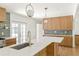 Contemporary kitchen with a large island, custom cabinetry, quartz countertops, and stainless steel appliances at 762 Rockbridge Nw Rd, Lilburn, GA 30047