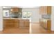 Bright kitchen with island seating, stainless appliances, designer lighting, and gray backsplash at 762 Rockbridge Nw Rd, Lilburn, GA 30047