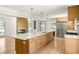 Bright and spacious kitchen with quartz countertops, stainless appliances, modern lighting and hardwood floors at 762 Rockbridge Nw Rd, Lilburn, GA 30047