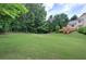 Expansive backyard with lush green lawn and a wooden deck, perfect for outdoor gatherings and recreation at 1047 Taso Trl, Acworth, GA 30101