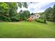 Expansive backyard with lush green lawn and a wooden deck, perfect for outdoor gatherings and recreation at 1047 Taso Trl, Acworth, GA 30101