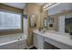 Bright and spacious bathroom featuring a large bathtub, vanity with sink, and ample countertop space at 1047 Taso Trl, Acworth, GA 30101
