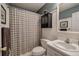 The bathroom offers a shower with checkered curtain and a sink with a white countertop at 1047 Taso Trl, Acworth, GA 30101