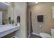Bright bathroom with a vanity and sink, a mirror, and a separate toilet area for added privacy at 1047 Taso Trl, Acworth, GA 30101